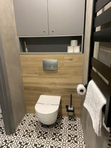 a small bathroom with a toilet in a room at Lux appartments в центре города в стиле Loft in Vinnytsya +22 photos