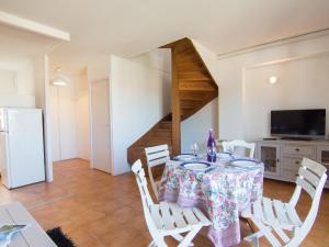 a dining room with a table and chairs and a staircase at Apartment les Terrasses du Cap by Interhome in Capbreton