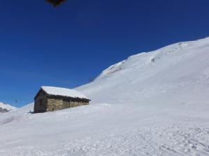 mały budynek na pokrytej śniegiem górze w obiekcie Apartment Les Tommeuses - Val Claret-30 by Interhome w mieście Tignes