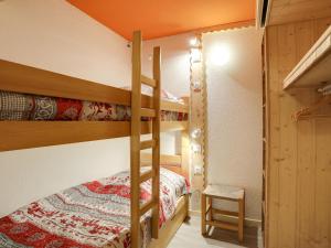 a bedroom with two bunk beds and a ladder at Apartment Pegase Phenix-65 by Interhome in Le Corbier