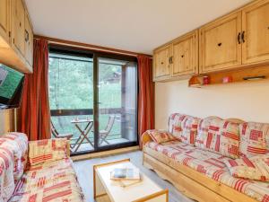 a living room with two couches and a large window at Apartment Pegase Phenix-65 by Interhome in Le Corbier +24 photos