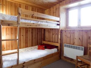 two bunk beds in a wooden room with a window at Apartment Chalet Le Tour by Interhome in Chamonix