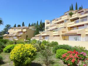 a building with flowers in front of it at Apartment Cadet Rousse-6 by Interhome in Le Lavandou