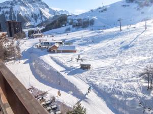 a snow covered ski slope with a ski lift at Studio Cosmos-7 by Interhome in Le Corbier