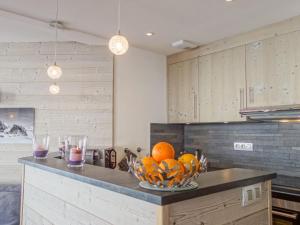 a kitchen with a bowl of oranges on a counter at Apartment Le Curling B - Val Claret-35 by Interhome in Tignes