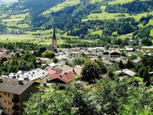 a view of a town with a church and a hill at Apartment Haus Achenstrasse-5 by Interhome in Bad Hofgastein