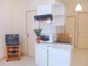 cocina con microondas y TV en Apartment Le Petit Robinson-6 by Interhome, en La Richardais