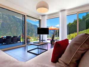 a living room with a couch and a table at Apartment Zenkei by Interhome in Leontica