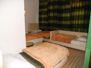 Postel nebo postele na pokoji v ubytování Riad Passiflora