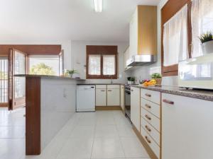 a kitchen with white counters and white appliances at Holiday Home Sandra by Interhome in Riumar