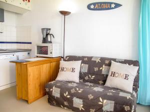 a living room with a couch in a kitchen at Apartment Grand Pavois-5 by Interhome in Mimizan-Plage