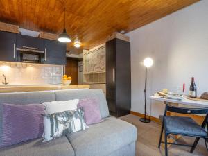 a living room with a couch and a kitchen at Studio Le Grand Pré-5 by Interhome in Tignes