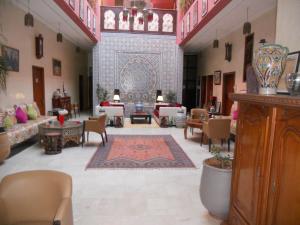 a living room filled with furniture and decor at Riad Passiflora in Fez