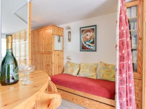 a room with a bed and a wine bottle on a table at Studio Palafour - Le Lac-2 by Interhome in Tignes