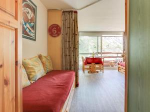 a living room with a red couch and a table at Studio Palafour - Le Lac-2 by Interhome in Tignes