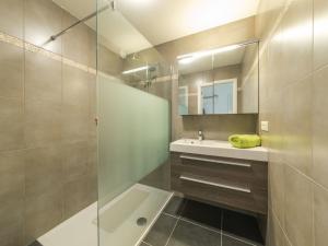 a bathroom with a shower and a sink and a mirror at Apartment Residentie Albatros by Interhome in Bredene