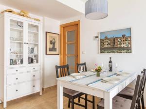 a white dining room with a white table and chairs at Apartment Parque Central by Interhome in Estepona