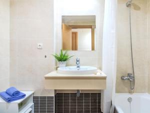 a bathroom with a sink and a mirror and a tub at Apartment Parque Central by Interhome in Estepona