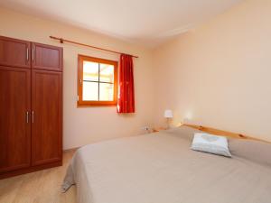 a bedroom with a large bed and a window at Holiday Home Golf Tee by Interhome in Balatonudvari