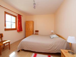 a bedroom with a large bed and a window at Holiday Home Golf Tee by Interhome in Balatonudvari
