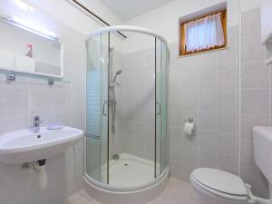 a bathroom with a shower and a toilet and a sink at Holiday Home Golf Tee by Interhome in Balatonudvari +24 photos