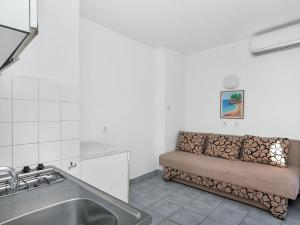 a kitchen with a couch in the corner of a room at Apartment Cico-8 by Interhome in Selca kod Bogomolja