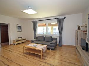 a living room with a couch and a table at Holiday Home Romy by Interhome in Mannsdorf an der Donau