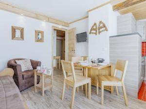 a living room with a table and chairs and a couch at Apartment Altitude 2100 by Interhome in Tignes