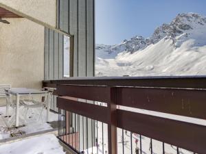 a balcony with a table and a view of a mountain at Apartment Les Hauts du Val Claret - Val Claret-21 by Interhome in Tignes