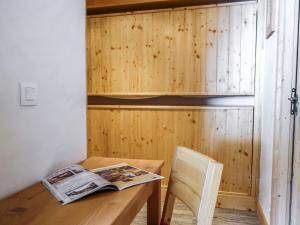 a room with a wooden table and a newspaper on it at Apartment Altitude 2100 by Interhome in Tignes