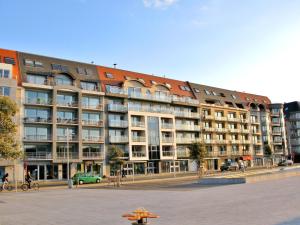 a large apartment building in front of a parking lot at Apartment Queen Mary 302 with balcony by Interhome in Bredene