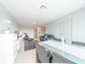 a kitchen and living room with a table and chairs at Apartment Queen Mary 302 with balcony by Interhome in Bredene