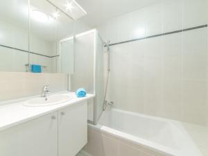 a white bathroom with a sink and a shower at Apartment Apartment 302 by Interhome in Bredene