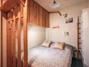 a bedroom with a bunk bed with two pillows at Apartment Les Olympiques-10 by Interhome in Les Boisses