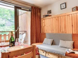 a living room with a table and a table sidx sidx sidx at Apartment Les Olympiques-10 by Interhome in Les Boisses