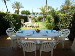 a white table and chairs with a bowl of fruit on it at Apartment Costa Blanca II by Interhome in Cambrils
