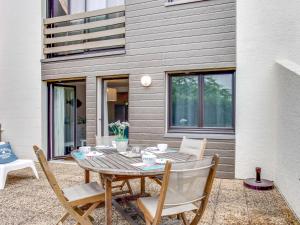 a patio with a table and chairs in front of a house at Apartment Cantegrit by Interhome in Capbreton