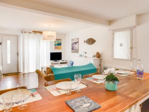 a dining room with a table and a living room at Apartment Cantegrit by Interhome in Capbreton