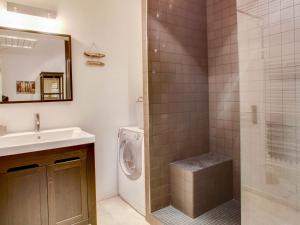 a bathroom with a sink and a washing machine at Apartment Cantegrit by Interhome in Capbreton
