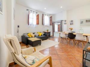 a living room with a couch and a table and chairs at Holiday Home Cueva de Lindaraja by Interhome in Granada