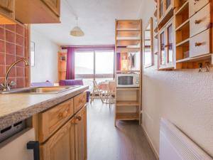a kitchen with a sink and a microwave at Studio Soyouz Vanguard-81 by Interhome in Le Corbier +25 photos