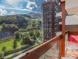 a balcony with a view of the mountains at Apartment Pegase Phenix-67 by Interhome in Le Corbier