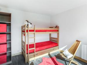 a room with two bunk beds and a chair at Apartment Pegase Phenix-67 by Interhome in Le Corbier