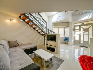 a living room with a couch and a staircase at Holiday Home Lana 1 by Interhome in Matulji