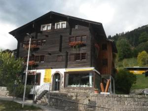 a large wooden house with flowers on the windows at Apartment ABC Ferienwohnung 1 by Interhome in Fiesch