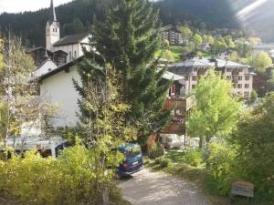 a car parked in a parking lot in front of a village at Apartment ABC Ferienwohnung 1 by Interhome in Fiesch