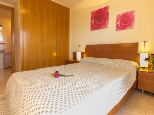 Un dormitorio con una cama blanca con un juguete. en Apartment Monaco by Interhome, en Cambrils