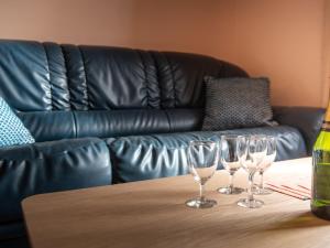 three wine glasses sitting on a table in front of a couch at Apartment Beaumer-2 by Interhome in Carnac-Plage