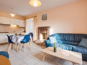 a living room with a couch and a table at Apartment Beaumer-2 by Interhome in Carnac-Plage