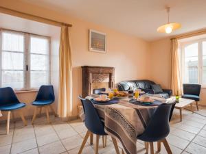 a living room with a table and chairs and a couch at Apartment Beaumer-2 by Interhome in Carnac-Plage